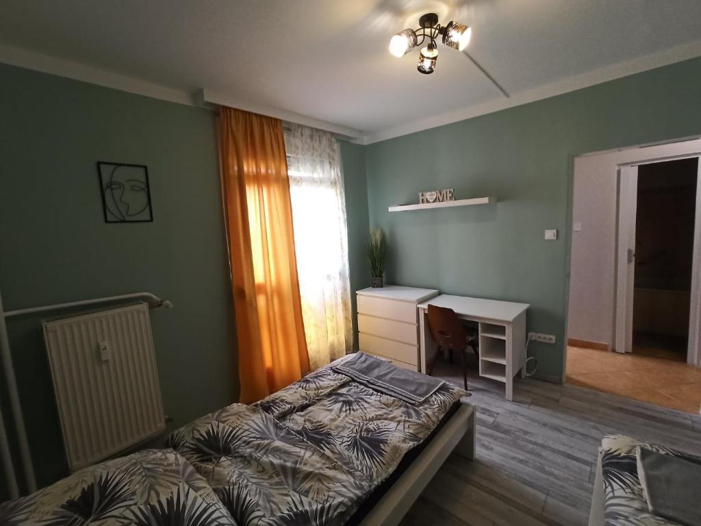 A bed or beds in a room at Áron Apartman Pécs