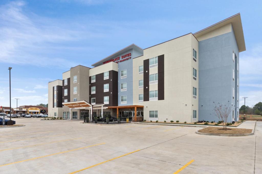 a large white building with a parking lot at TownePlace Suites by Marriott White Hall in White Hall