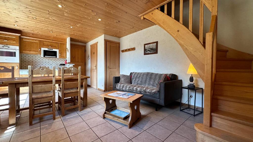 a living room with a couch and a kitchen at L'ourson in Le Grand-Bornand