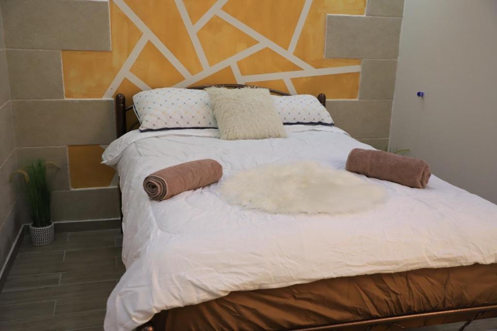 a bedroom with a bed with a wooden headboard at Marina room in ‘Akko