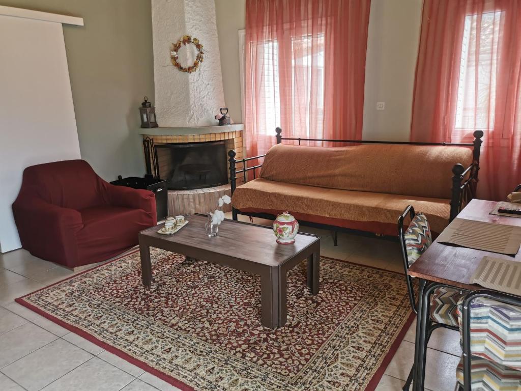 a living room with a couch and a coffee table at Thalia's Stone house in Ipsilándis