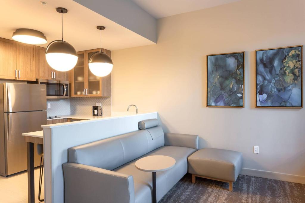 a kitchen with a couch and a table in a room at Residence Inn Palm Beach Gardens in Palm Beach Gardens