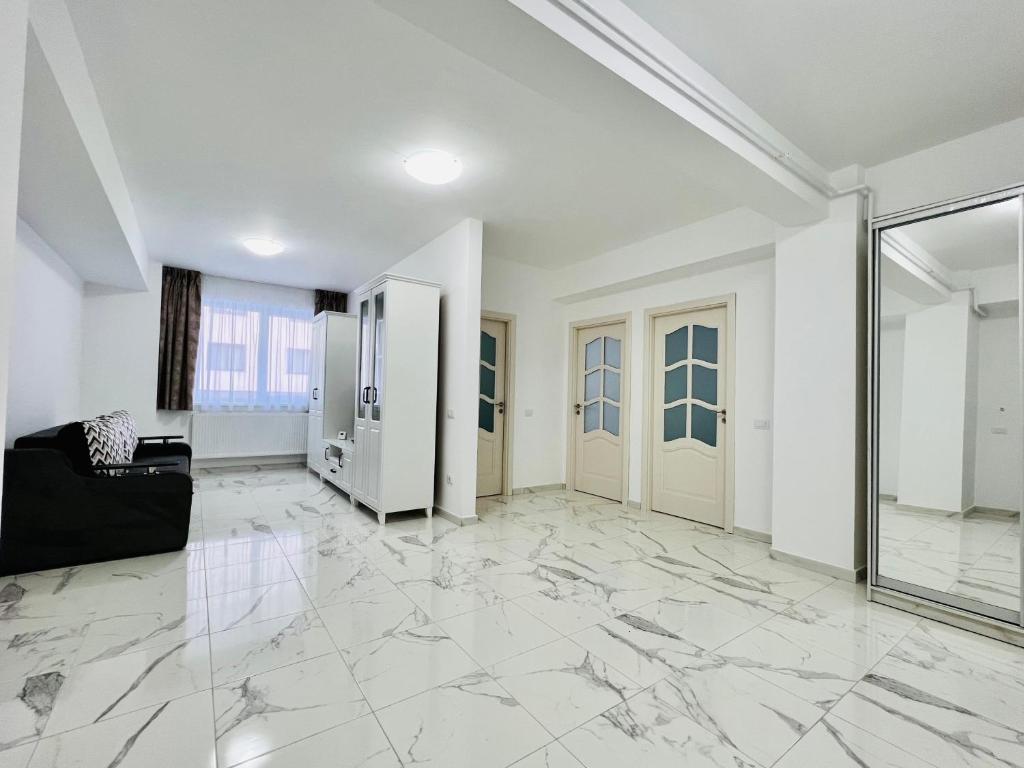 an empty living room with marble floors and a glass door at Altheda Living White House 29F-2 in Suceava