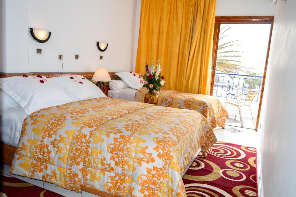 Postel nebo postele na pokoji v ubytování Hotel Sindibad