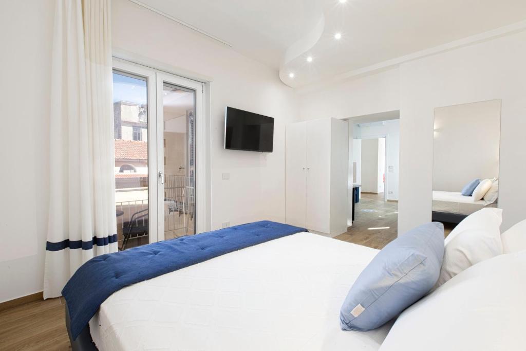 Postel nebo postele na pokoji v ubytování YourHome - Lidia Rooms & Suites