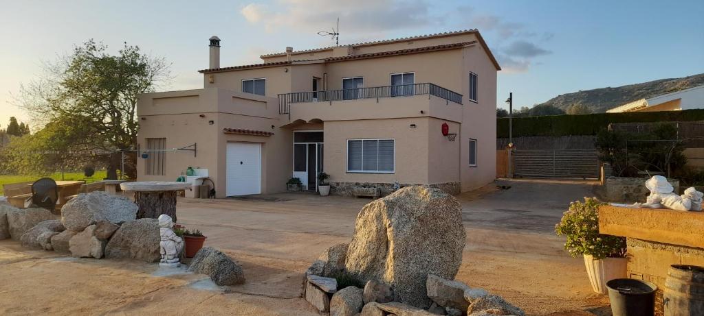 a house with a lot of rocks in front of it at Casa L'Era 1967 in Pau