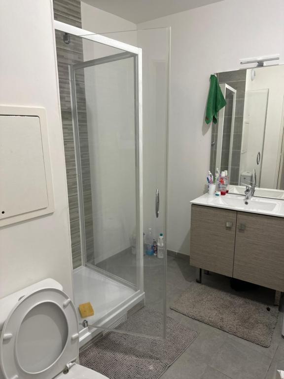 a bathroom with a shower and a toilet and a sink at Myhotel19 in Noisy-le-Grand