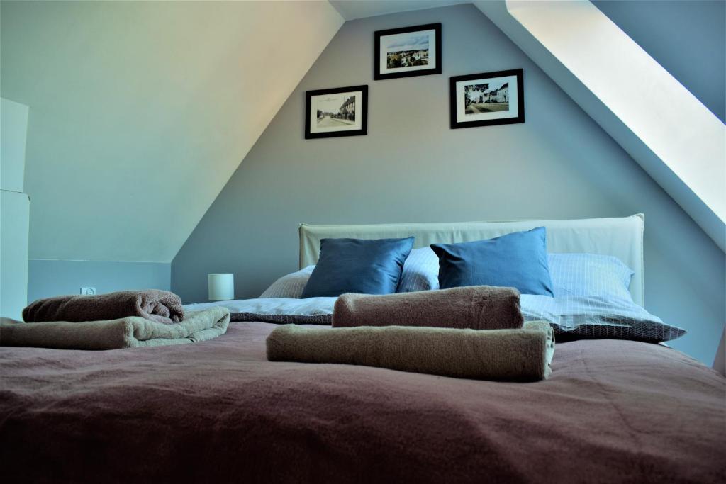 a bedroom with a bed with two pillows on it at Apartament Starówka in Tuchola