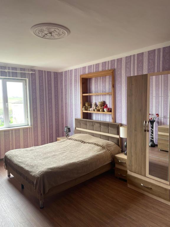 a bedroom with a large bed and a window at wine valley in Udabno