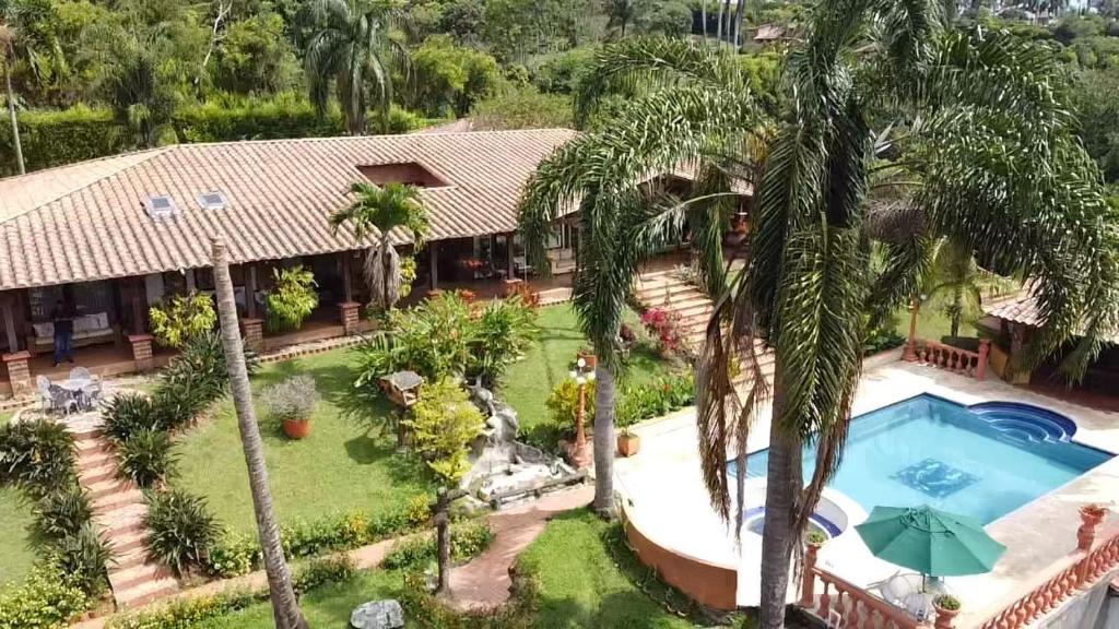 an aerial view of a house with a swimming pool and palm trees at Finca hotel Villa Camila in Copacabana