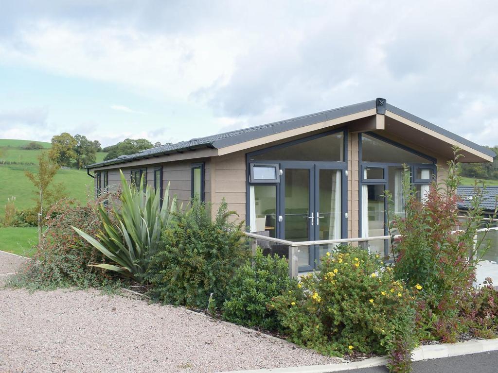 a small house with a lot of windows at Lodge 5 in Kinlet