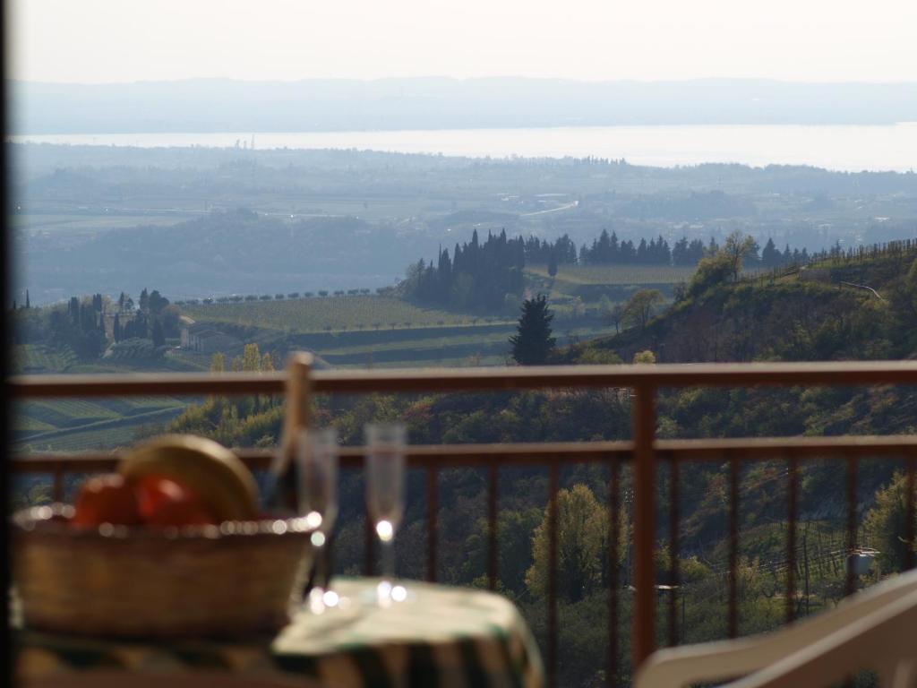 a balcony with a table and a view of a valley at Casa di Licia in Volargne