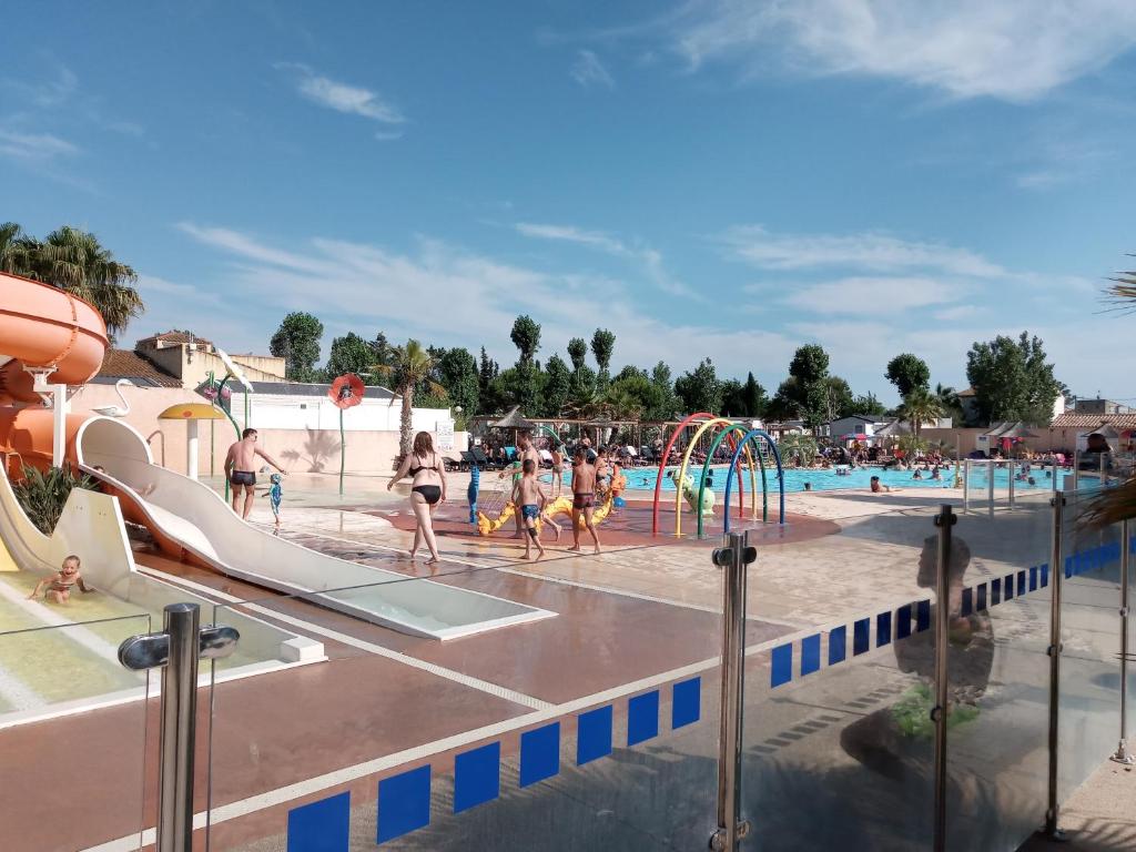 a group of people playing in a water park at Valras-Plage, les sables du midi ,mobil home in Sérignan