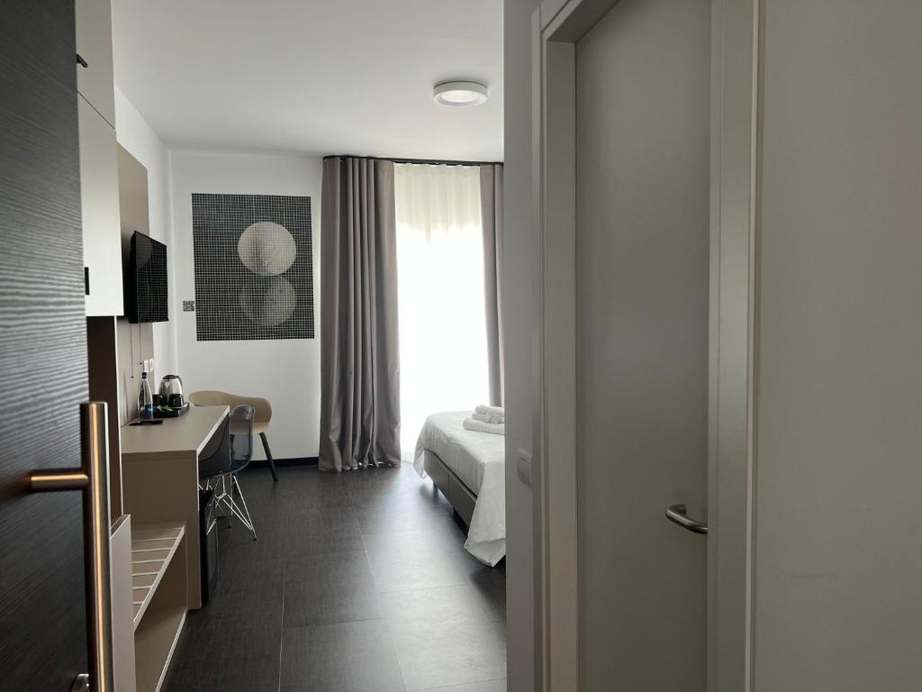 Postel nebo postele na pokoji v ubytování HOTEL MOSAICO