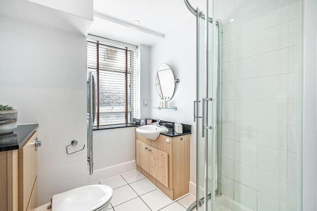 a bathroom with a shower and a toilet and a sink at Luxurious appartment in Sloane street in London