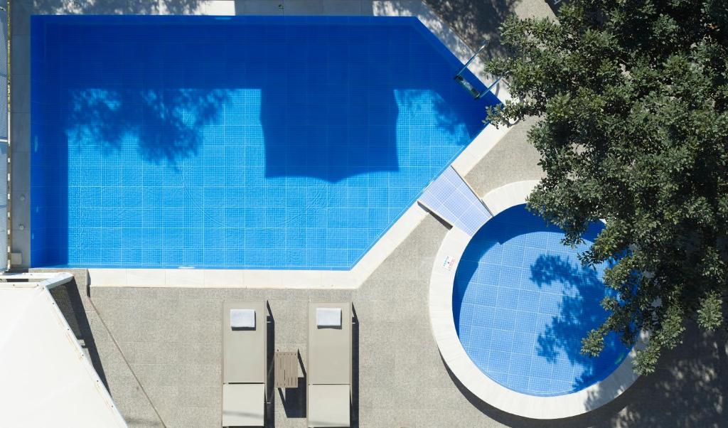 a large swimming pool with a blue pool at Kastellakia Executive Villa in Rethymno Town