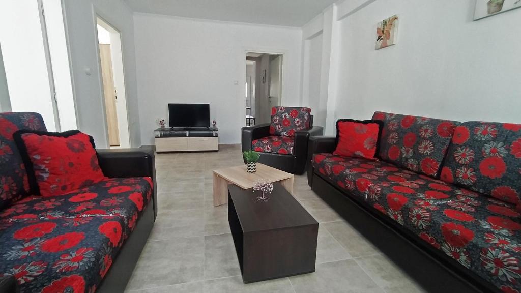 a living room with two couches and a coffee table at Cozy ground floor house in Agia Triada