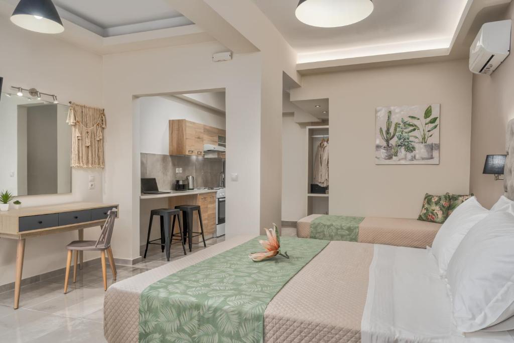 a hotel room with two beds and a kitchen at Rania's Deluxe Studios in Tsilivi