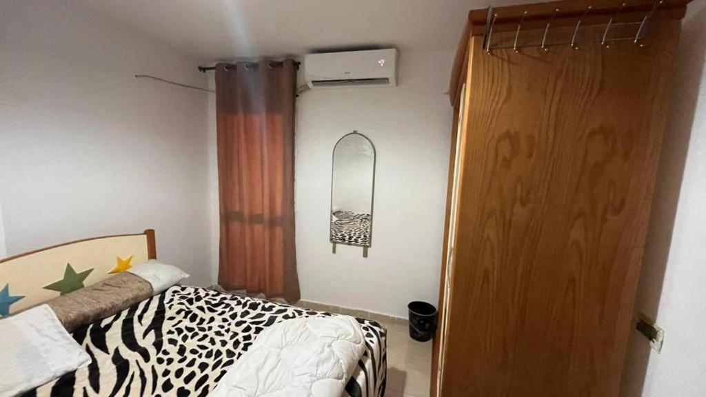 - une chambre avec un lit et une porte en bois dans l'établissement مصيف بلطيم, 