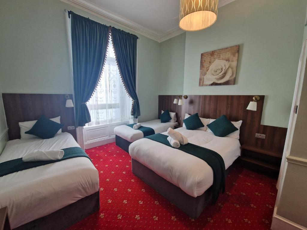 Postel nebo postele na pokoji v ubytování Lyndon Guesthouse