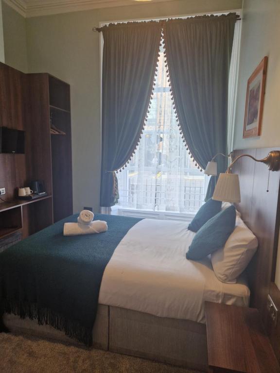 Postel nebo postele na pokoji v ubytování Lyndon Guesthouse