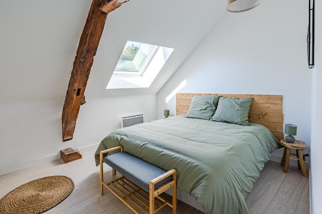 a bedroom with a large bed and a window at Le noé in Caen