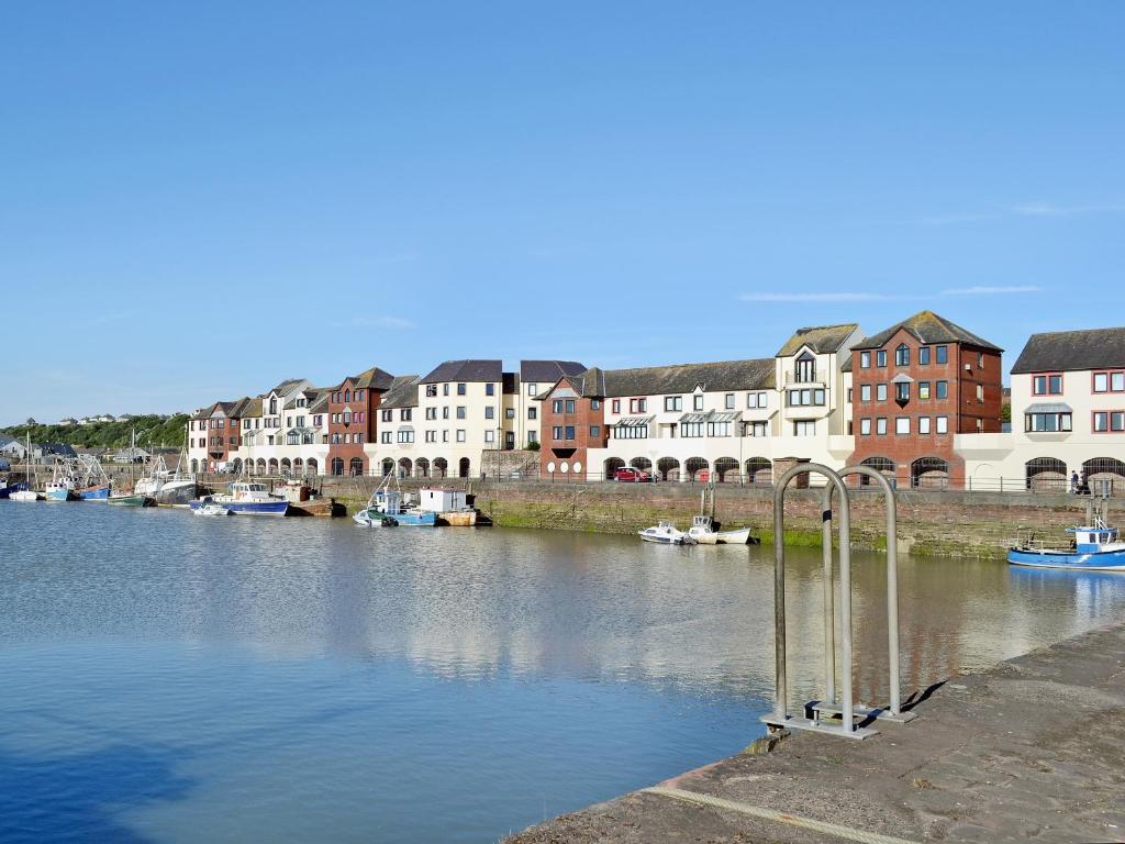 a view of a river with buildings and boats at Harbour Gates in Maryport