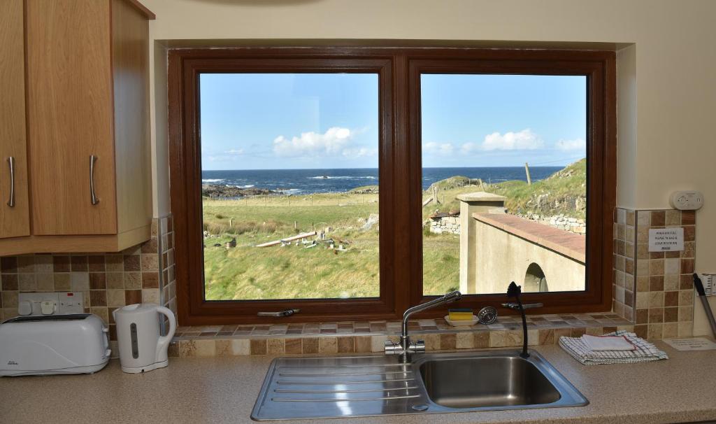 a kitchen counter with a sink and a window at Sea View Apartment in Downings
