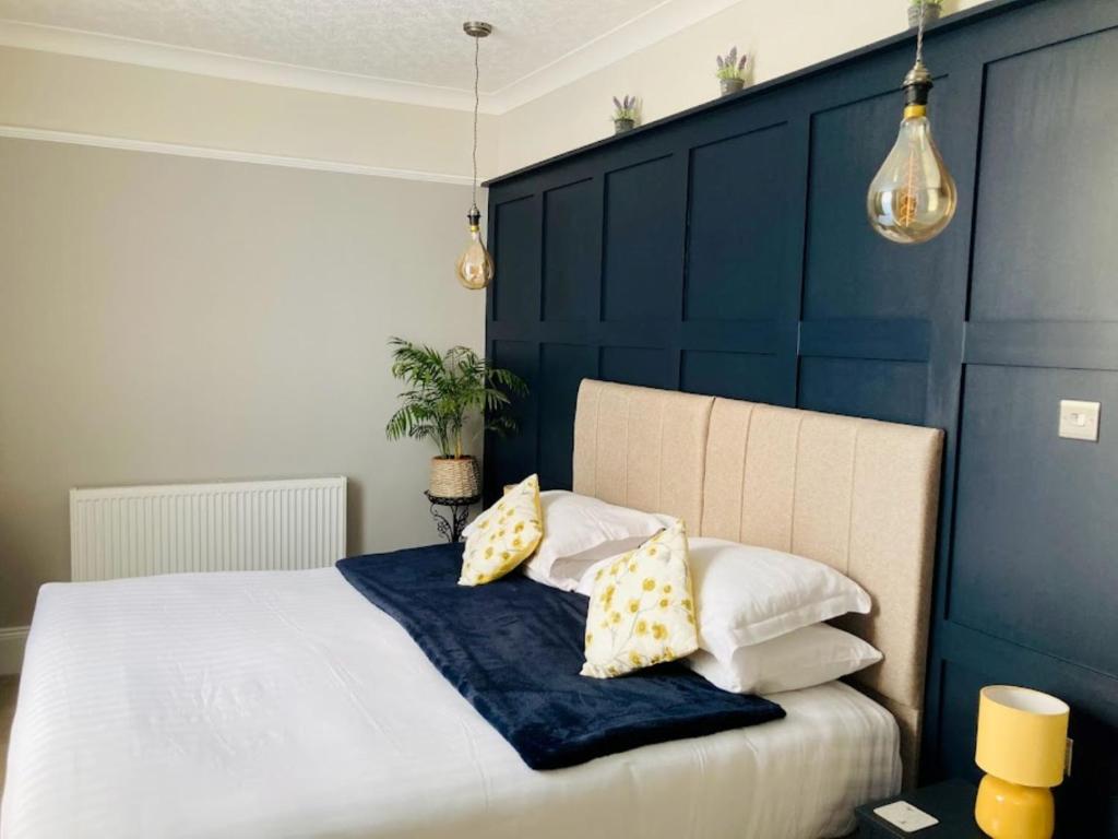 a bedroom with a bed with pillows on it at The Morley in Torquay