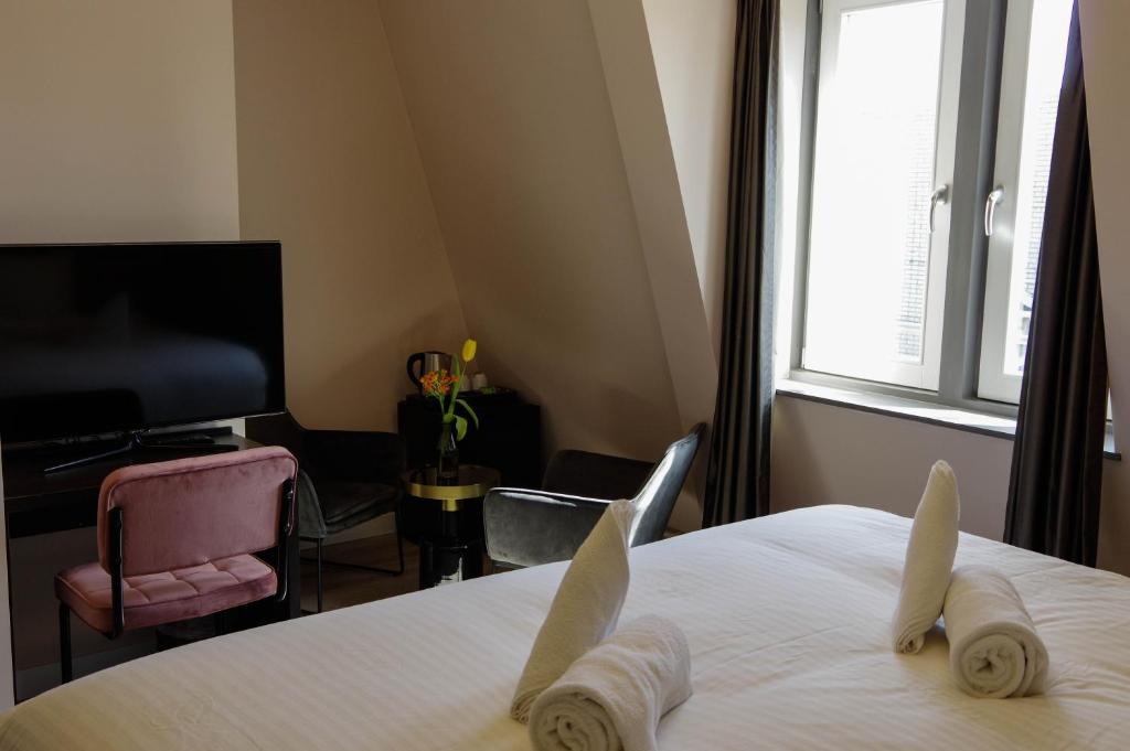 Postel nebo postele na pokoji v ubytování Hotel de Duif Lisse - Keukenhof