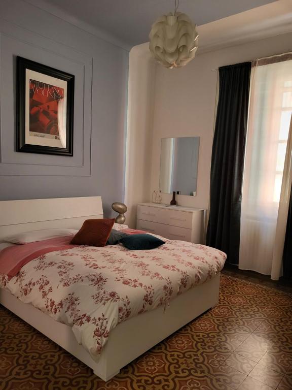 a bedroom with a bed and a lamp and a window at ALFIERI Guest House in Vercelli