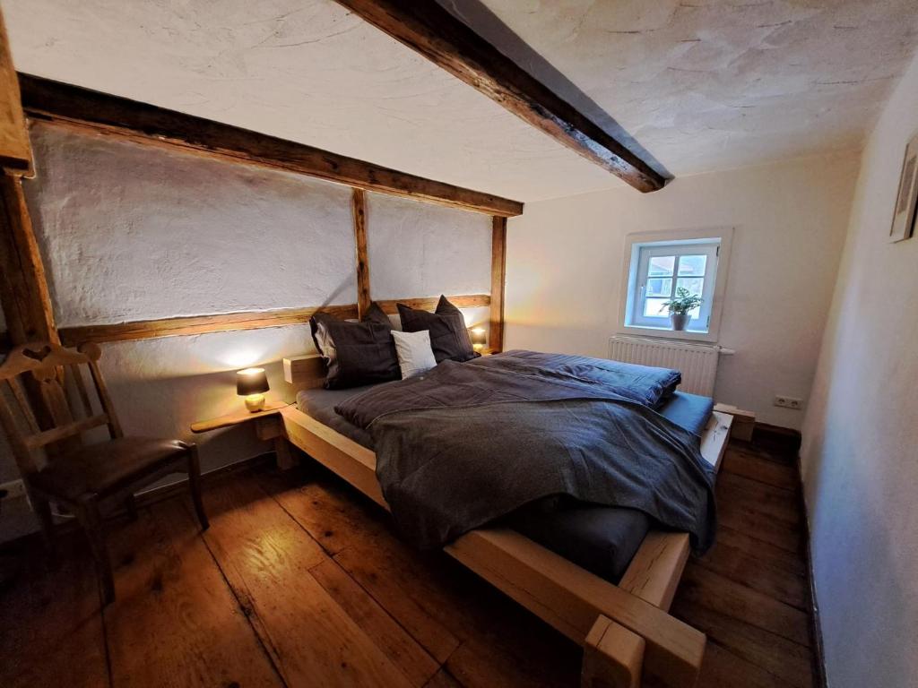 a bedroom with a large bed and a window at AuenGut-Bertsdorf in Bertsdorf