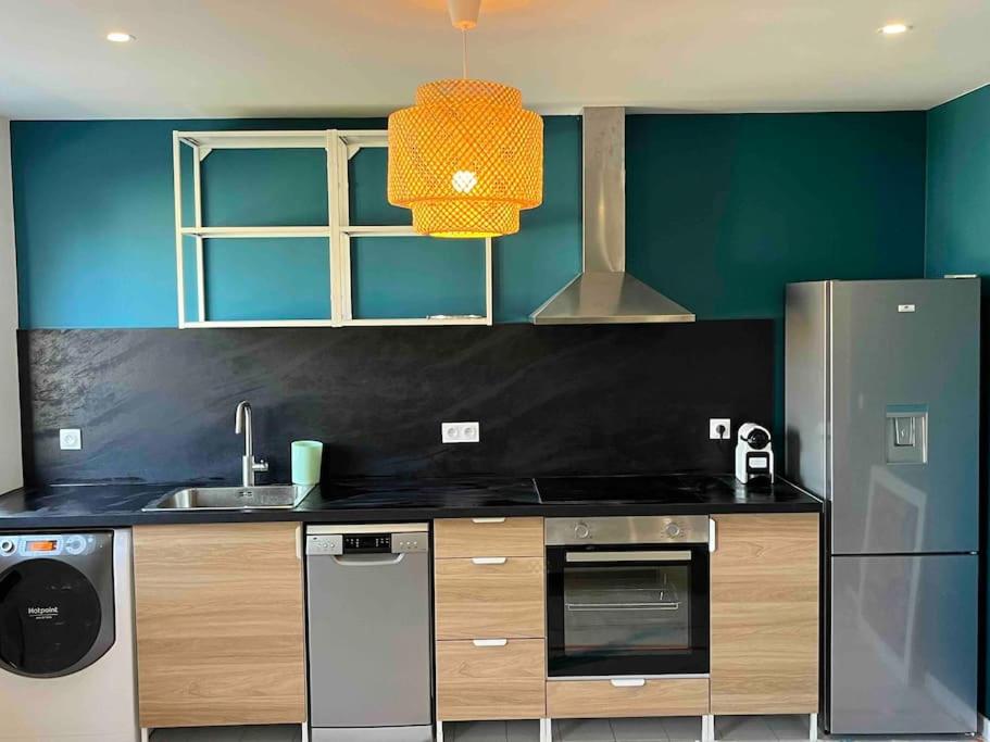 a kitchen with a sink and a refrigerator at A1 neuf 2023 - ORLY - PARIS EXPO - 5 chambres - 16 couchages in Antony