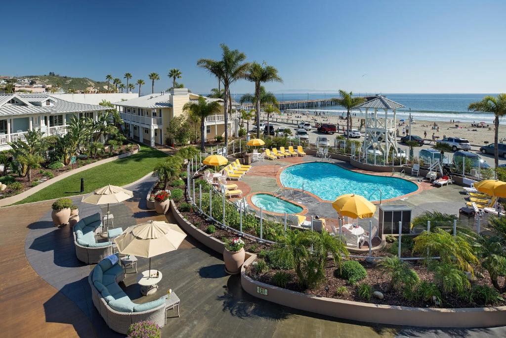 an aerial view of a resort with a swimming pool and the beach at Avila Lighthouse Suites in Avila Beach