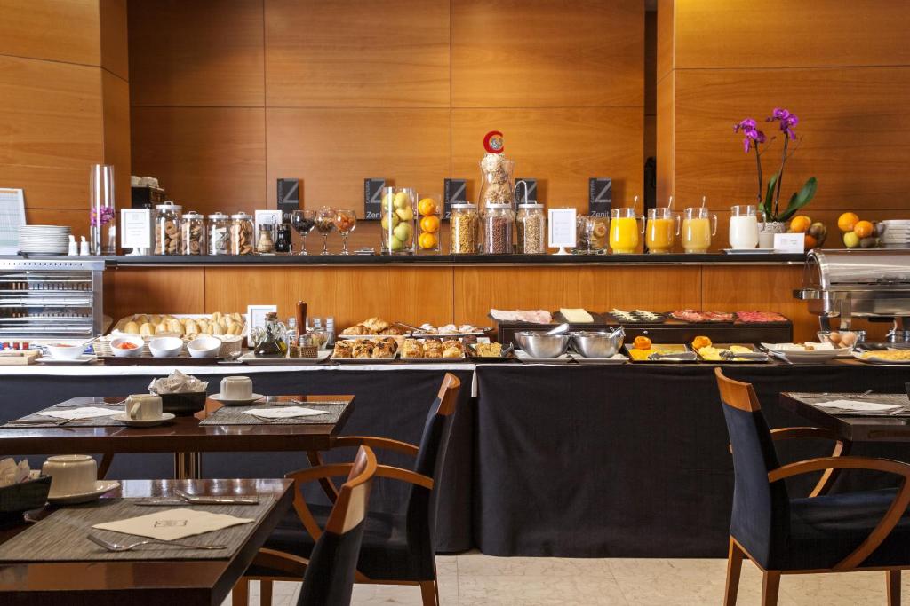 a restaurant with a buffet of food on a table at Zenit Málaga in Málaga