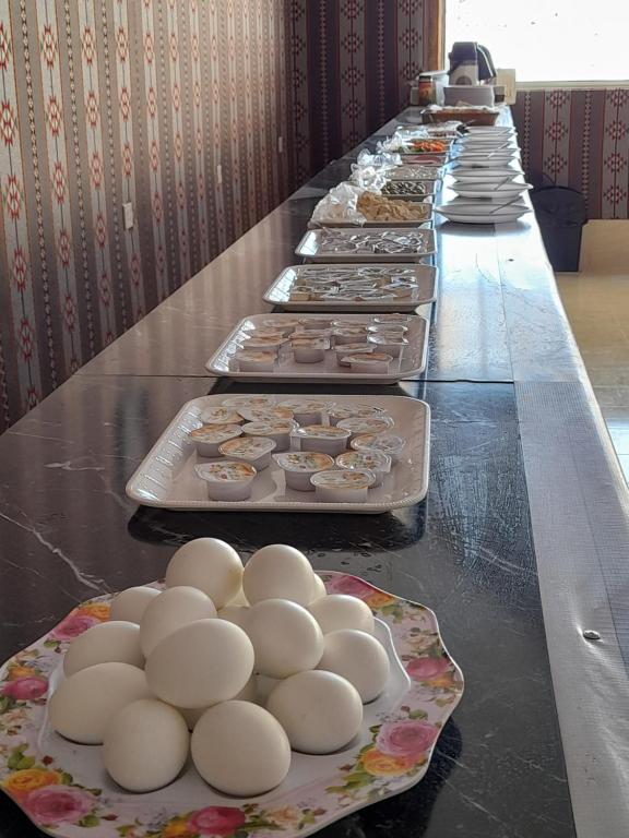a long buffet line of plates of eggs and food at rum rema camp in Wadi Rum
