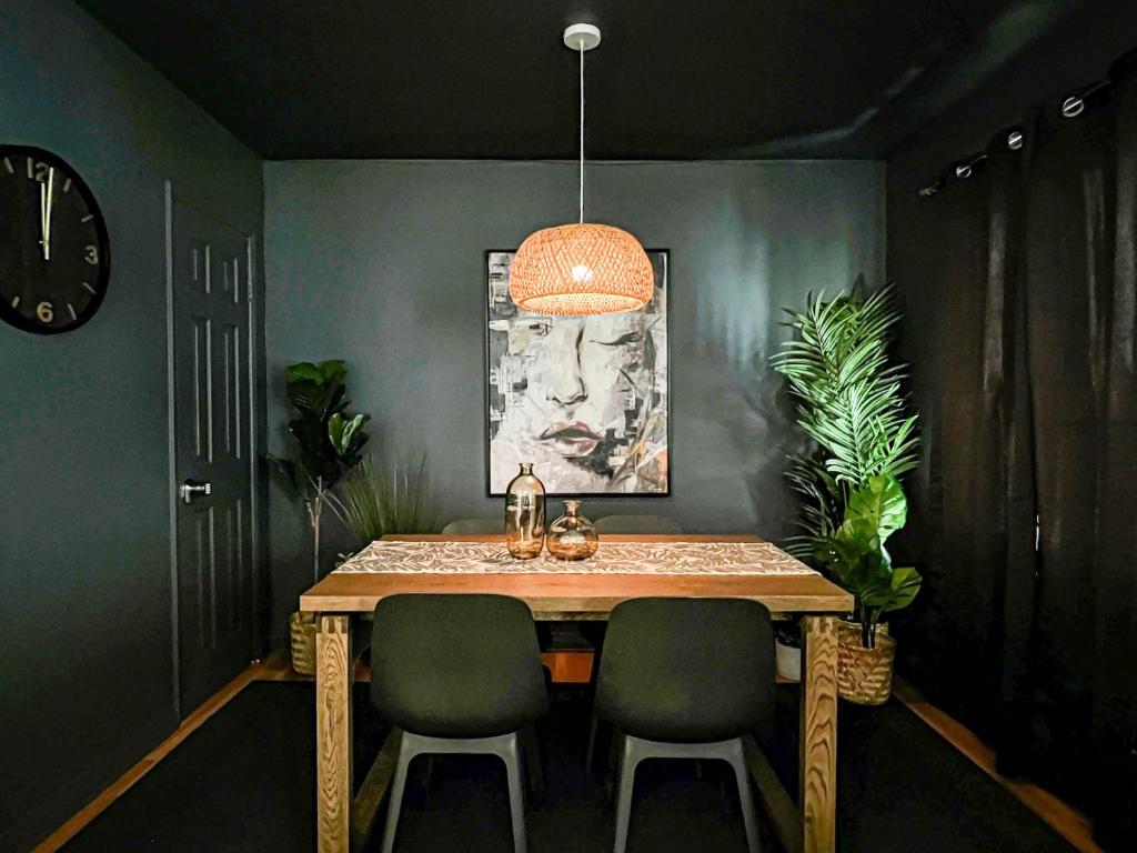 a dining room table with two chairs and a clock at Diamond in LA - AM3-CUL in Los Angeles