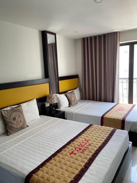 Postel nebo postele na pokoji v ubytování Tokia hotel nha trang