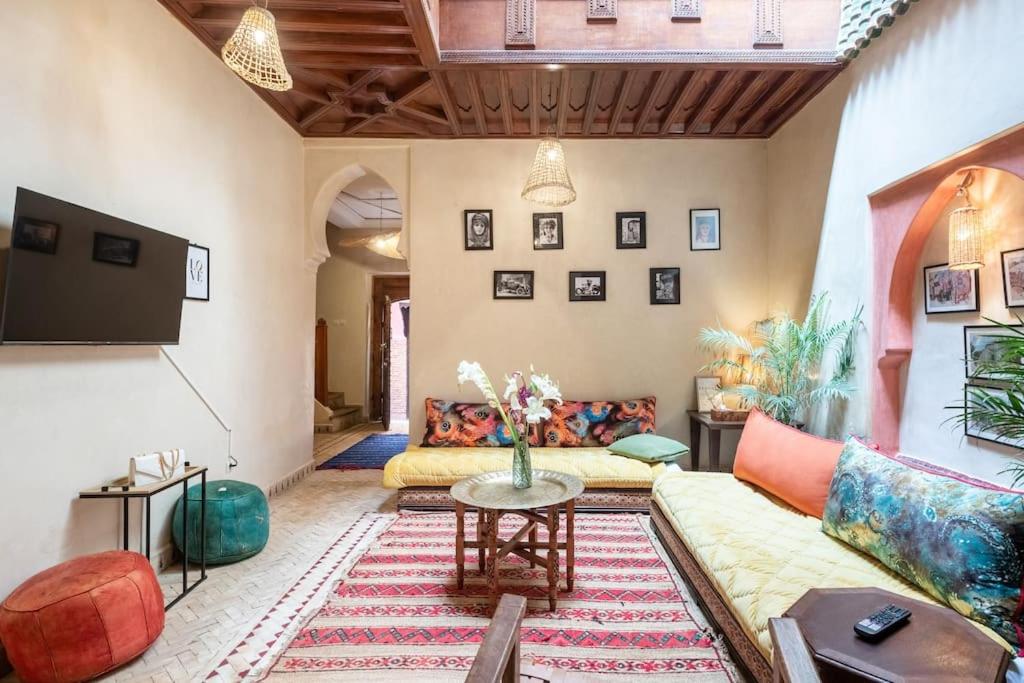 a living room with a couch and a table at Central Entire and exclusive house ,Ryad no shared in Marrakesh