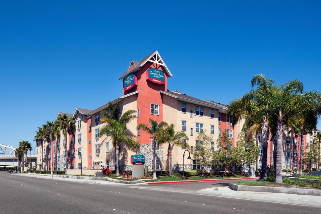 a large building with a clock tower on a street at TownePlace Suites Los Angeles LAX Manhattan Beach in Hawthorne