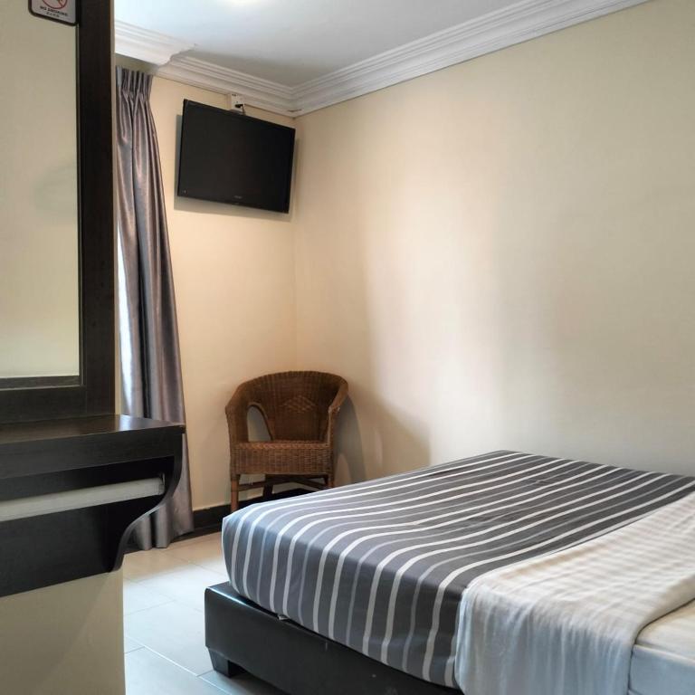 Postel nebo postele na pokoji v ubytování Hong Kong Hotel