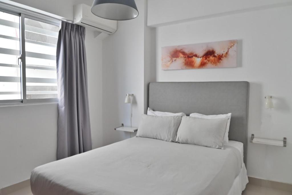 Postel nebo postele na pokoji v ubytování Palmer Suites