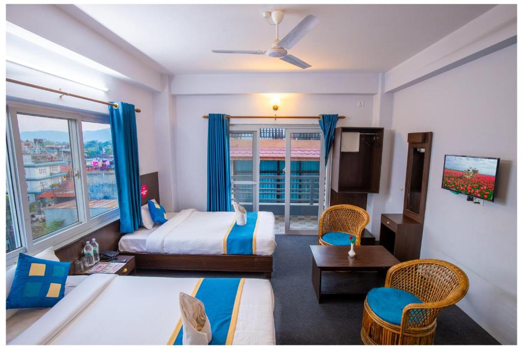 ein Hotelzimmer mit einem Bett und einem Fenster in der Unterkunft Hotel Tulip Pokhara Inn in Pokhara