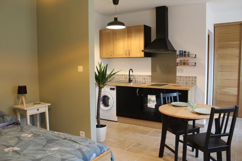 a kitchen and dining room with a table and a stove at Studio 30m² à Billey in Billey