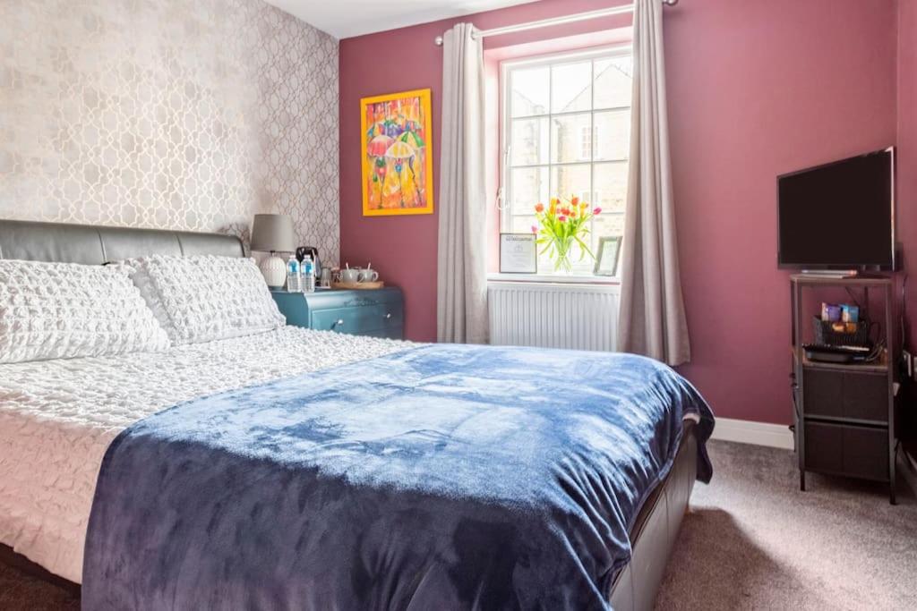 una camera con letto, finestra e televisore di Poppy's Place a Oakworth