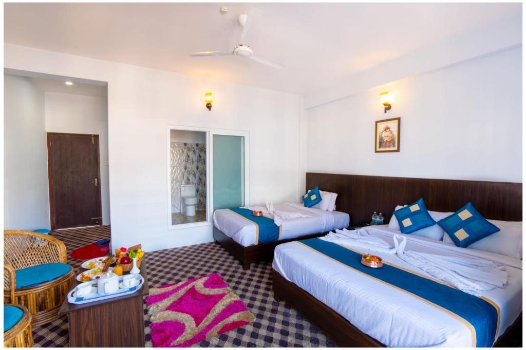 Letto o letti in una camera di Hotel Tulip Pokhara Inn
