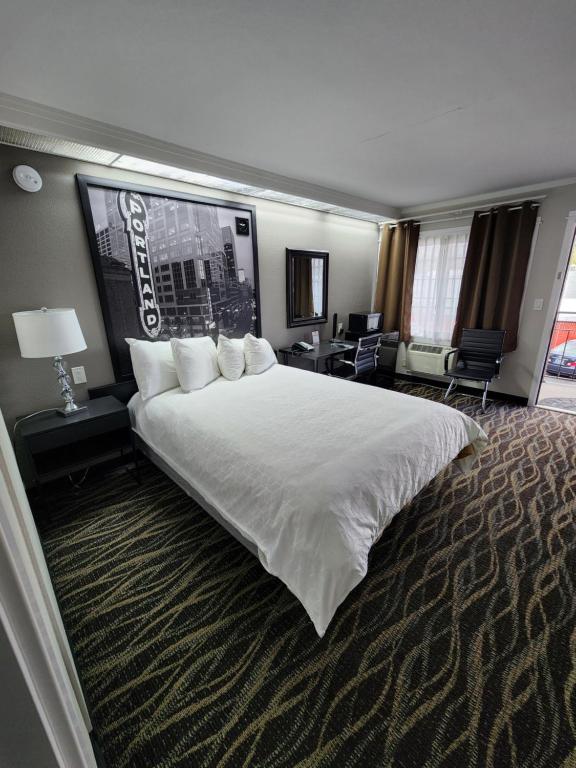 a large white bed in a hotel room at Executive Lodge in Portland