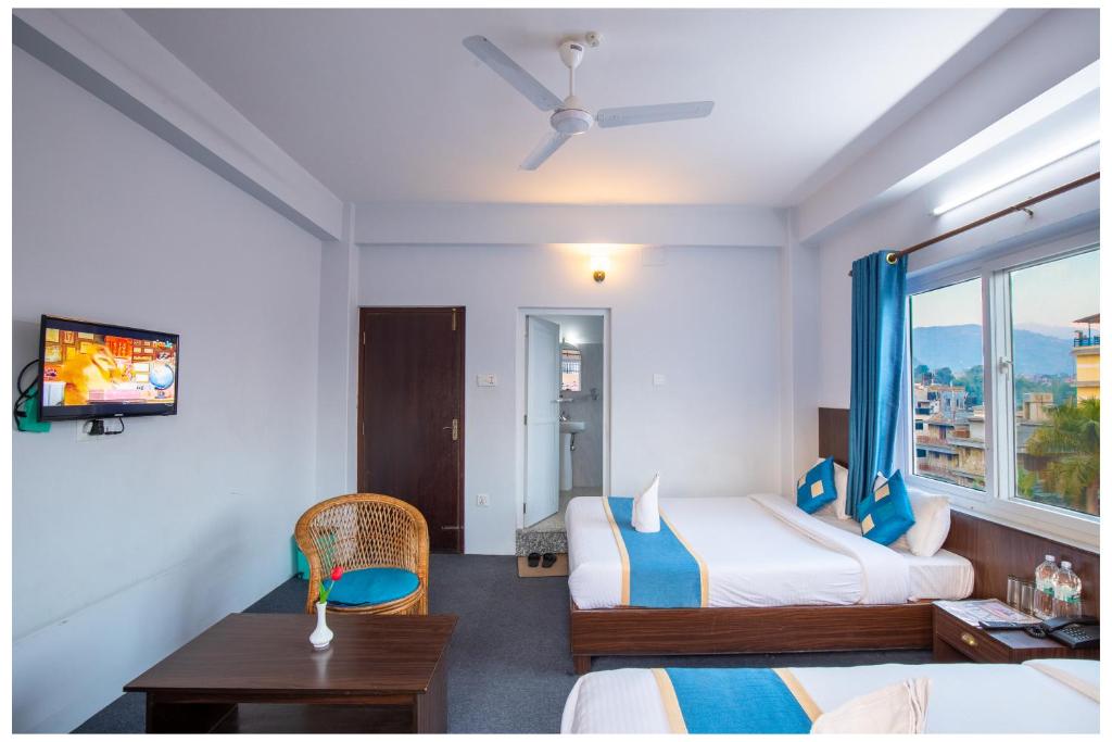 Letto o letti in una camera di Hotel Tulip Pokhara Inn