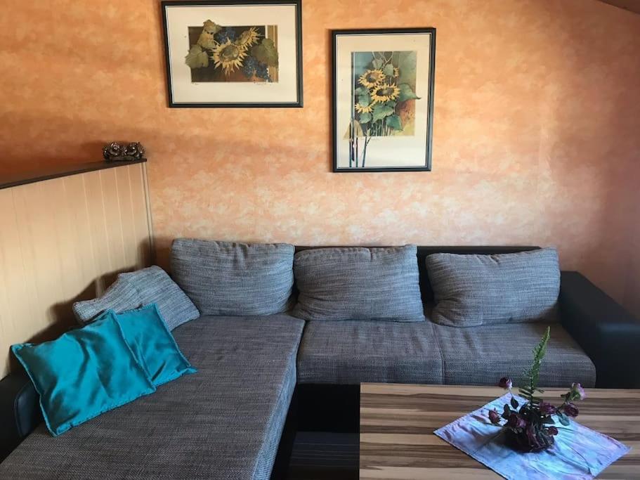 a living room with a couch and a table at Gemütliche Wohnung an der Nordseeküste 3 in Westerholt