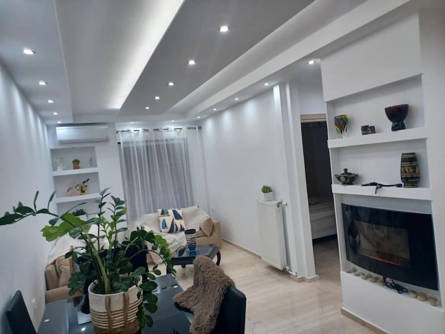a living room with a couch and a fireplace at Cozy Renovated Apartment in Athens